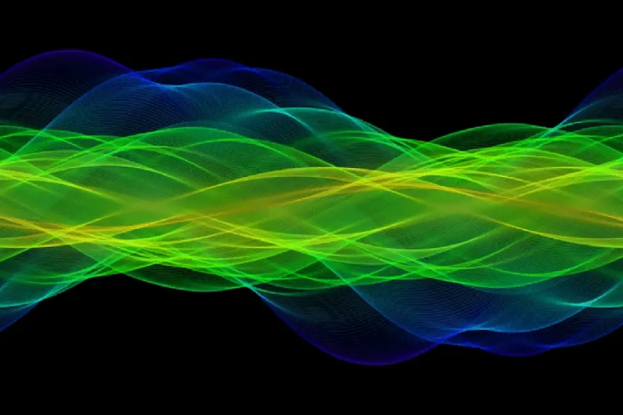 Green, yellow, and blue waves of light run through the center of the image.