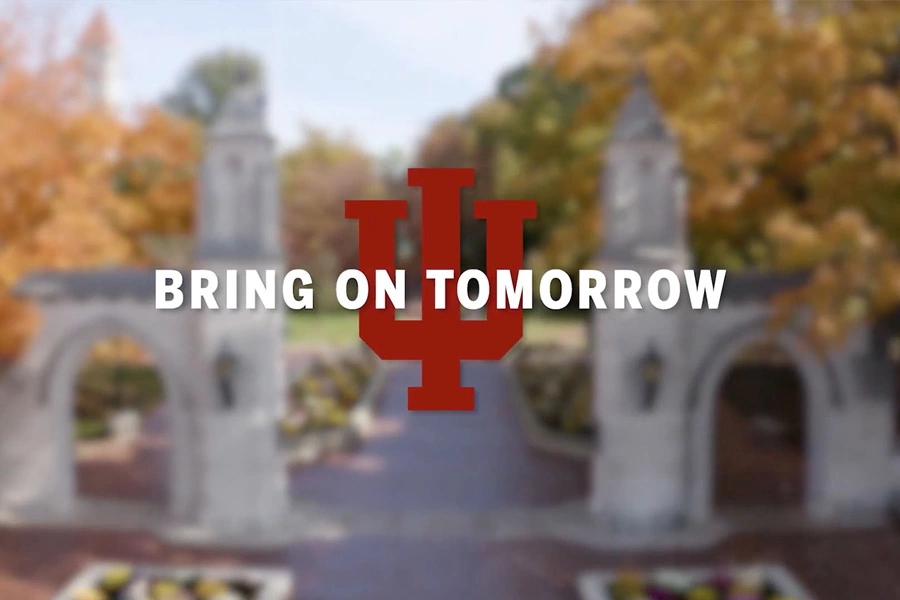 The words Bring On Tomorrow and the IU trident superimposed over the IU Bloomington entrance.