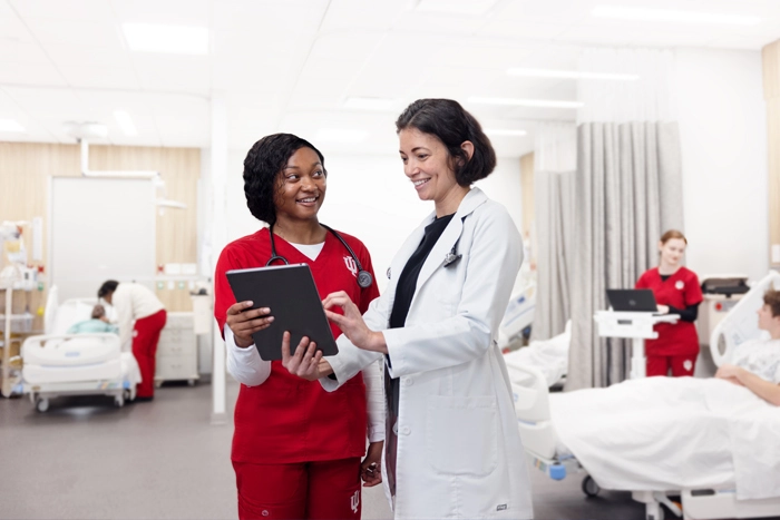 Two healthcare providers talk about patient care.