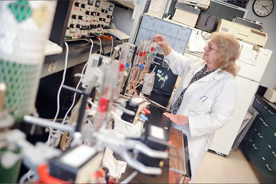 A researcher uses lab equipment to gather samples.