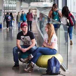 iu columbus students talk in hallway square 320x320